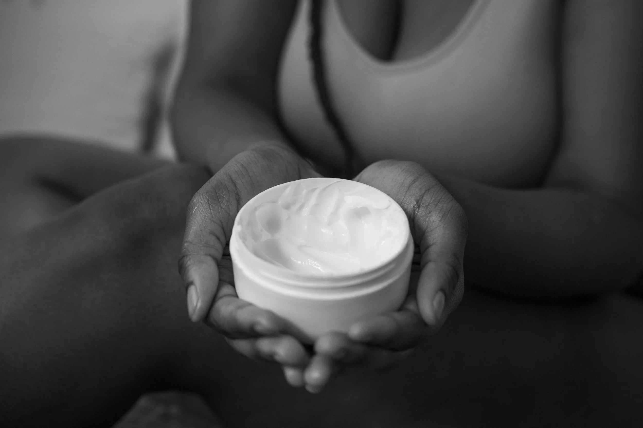 high-angle-hands-holding-cream-container.jpg