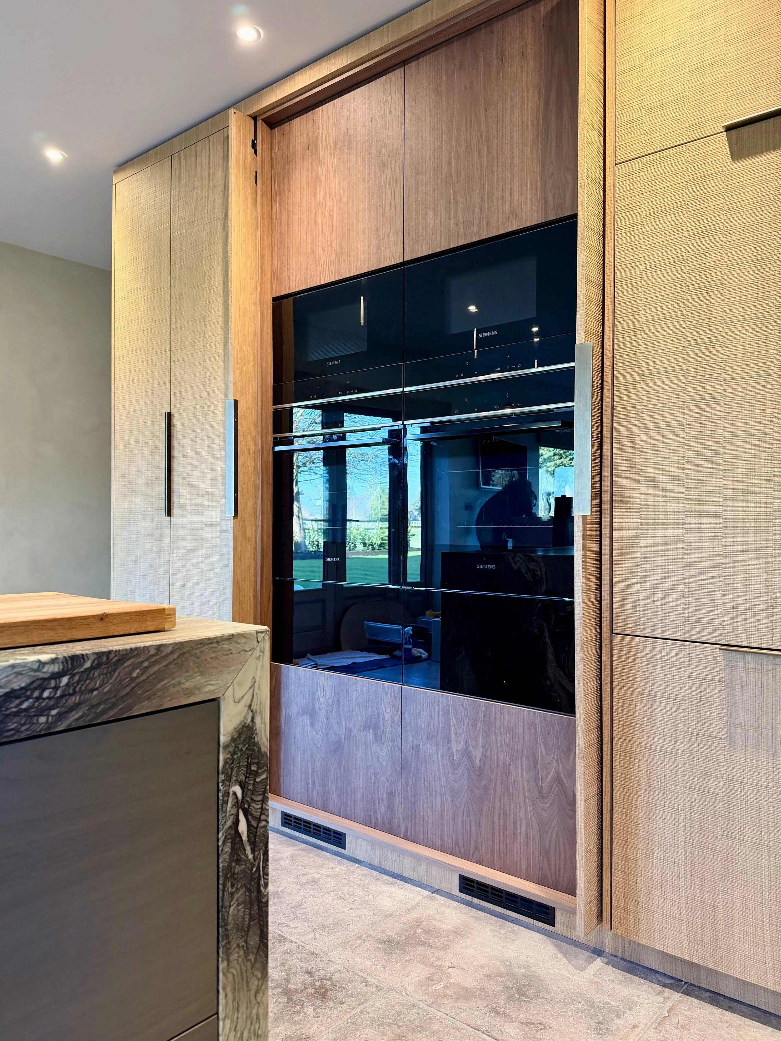 Slide and Hide doors reveal double warming drawers, double ovens and double microwaves.