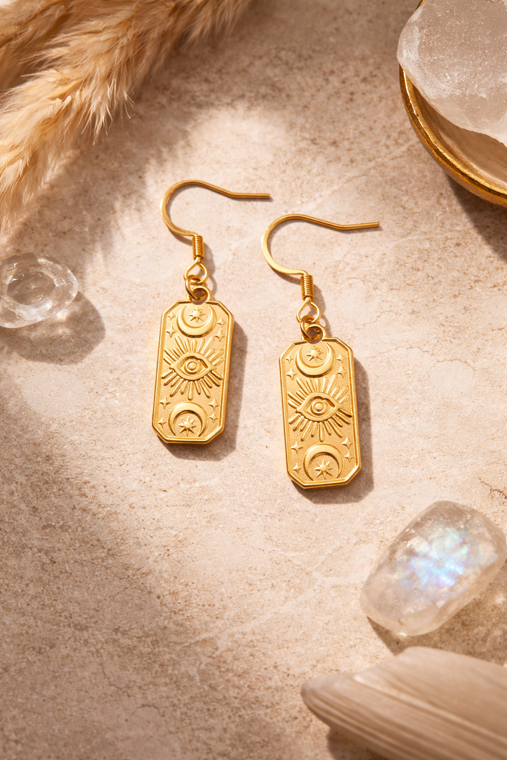 Golden earrings with mystical symbols
