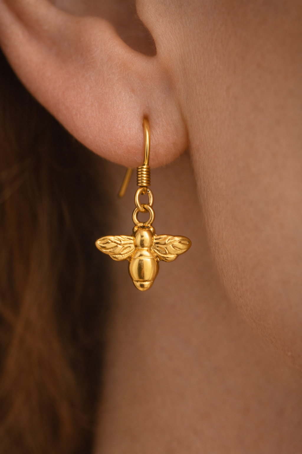 closeup bee earrings model.png