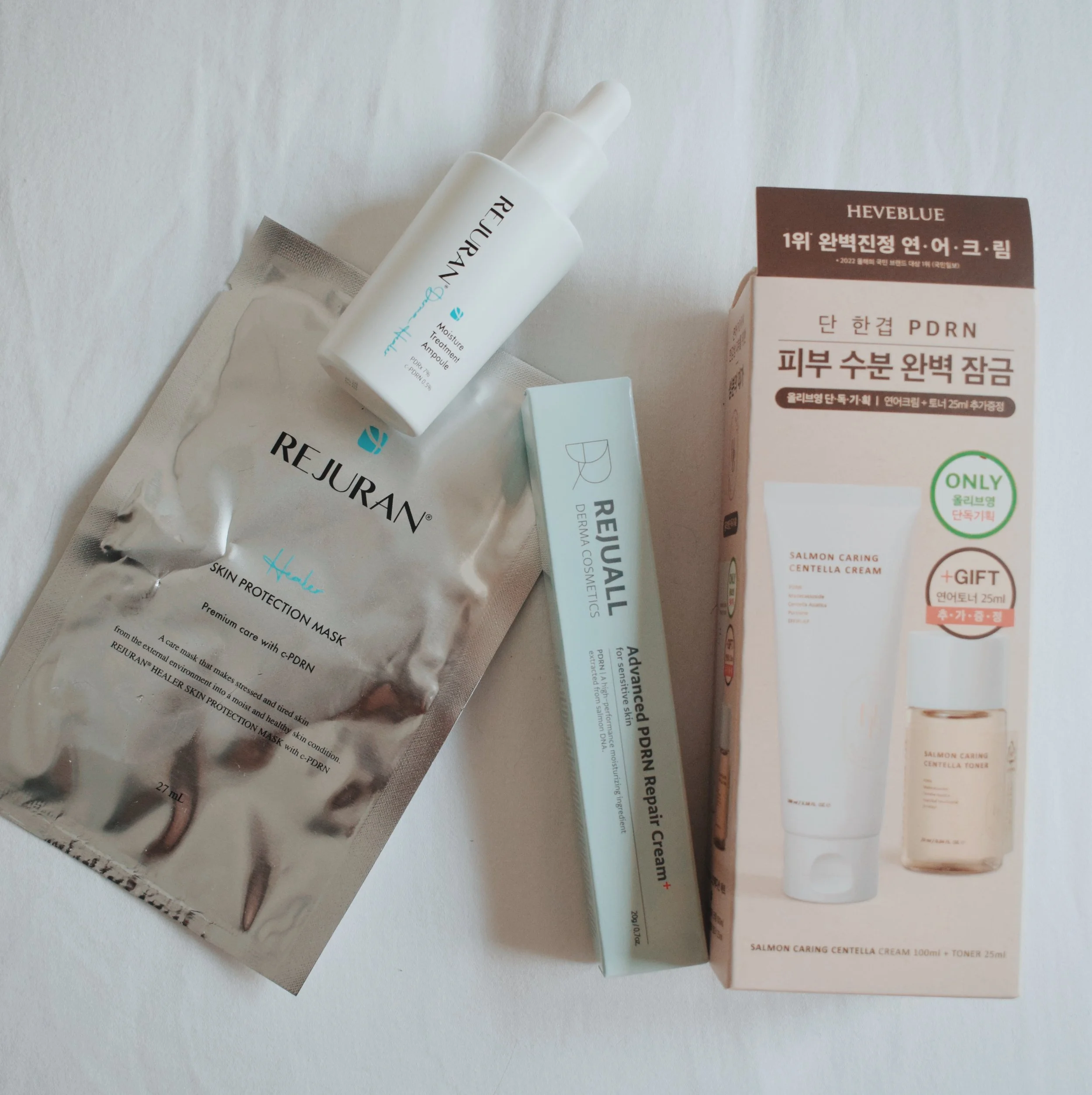 A flatlay shot of 4 different products all containing PDRN