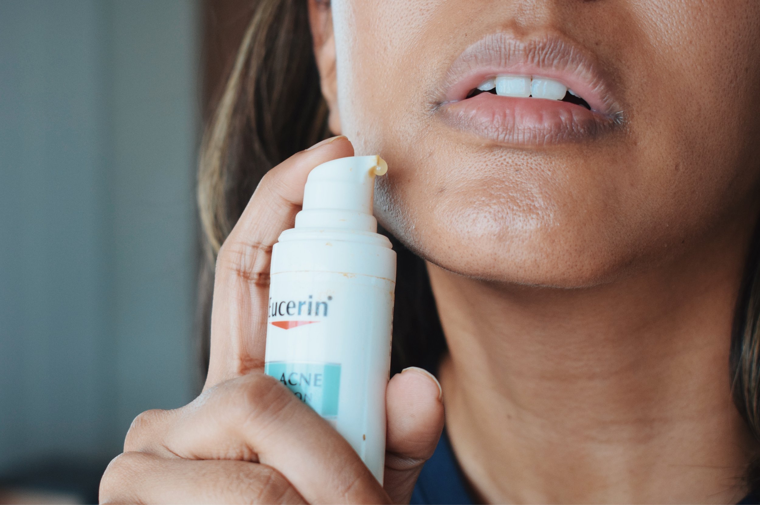 woman applying eucerin thiamidol serum to face