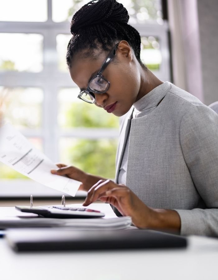 A therapist receiving business coaching calculating business numbers for private practice.