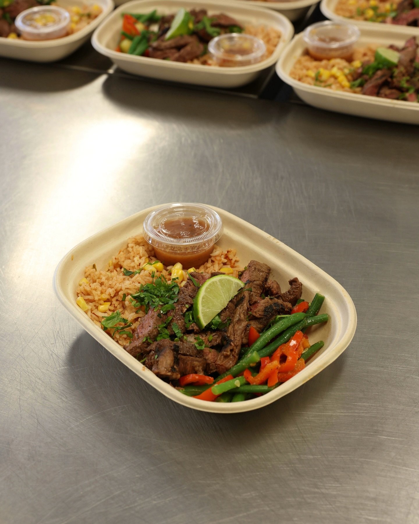 Carne Asada Bowl

Juicy Wagyu top sirloin marinated in citrus, garlic, and smoky spices, served over Spanish rice with corn, green beans, zucchini, and bell peppers. Finished with a bold Chile de &Aacute;rbol salsa for the perfect kick.

Back on the 