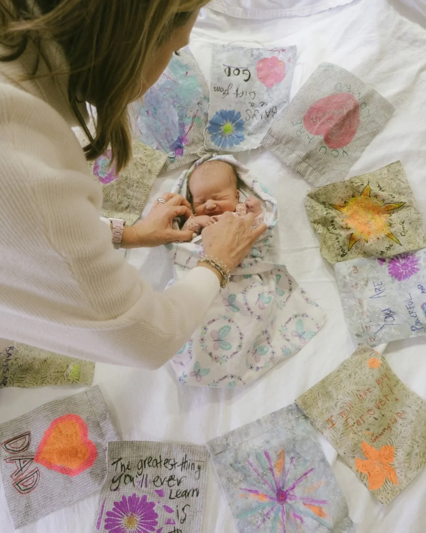 Tiny baby, big village. All around this little one are messages, color, and so much love, you can feel it. This baby walked into a whole circle of people already cheering them on. These early days are soft and new, full of getting to know each other,