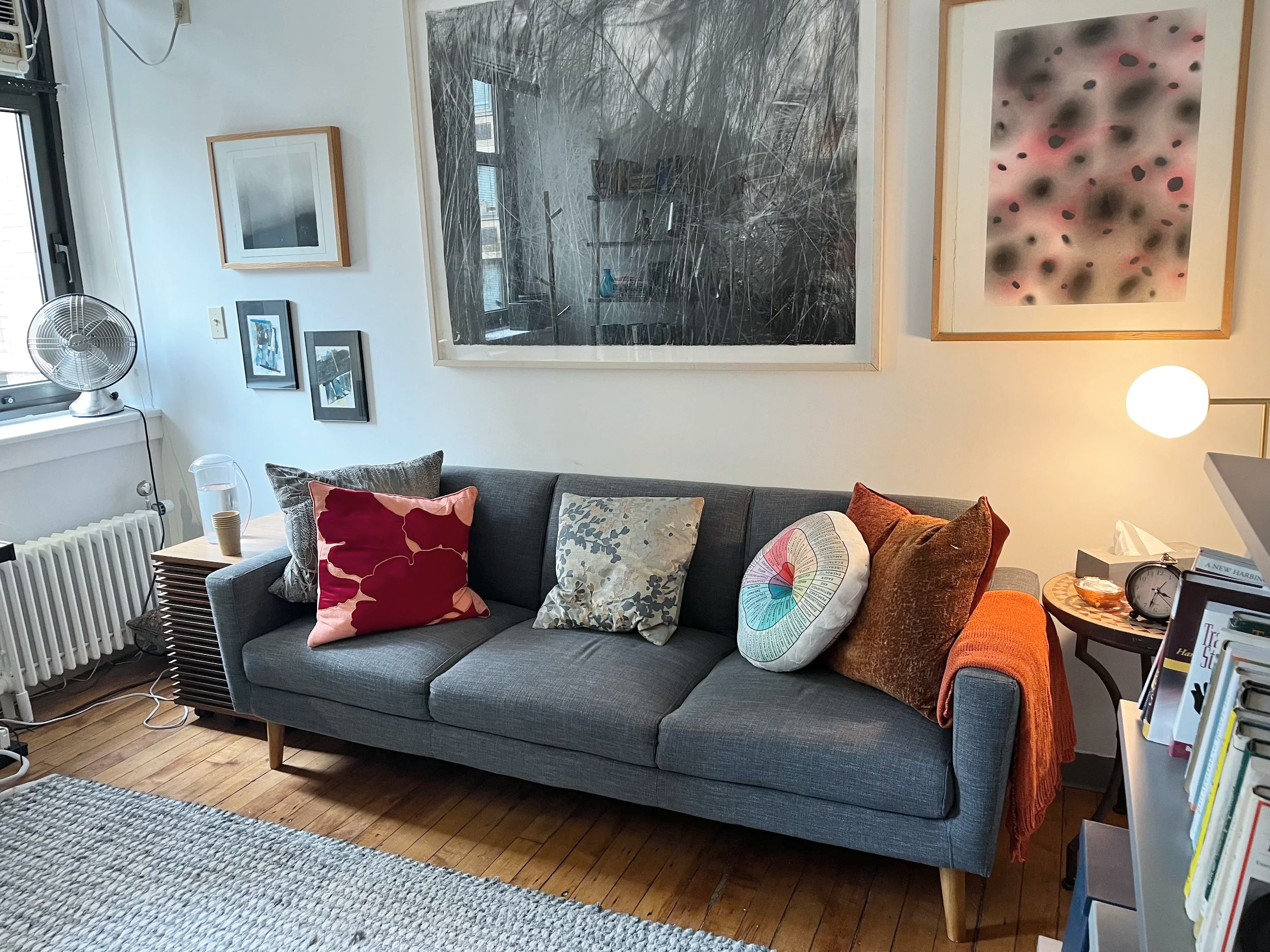 A photo of Laura's peaceful and quiet therapy office, picturing a comfortable couch with a window and light streaming into the room.