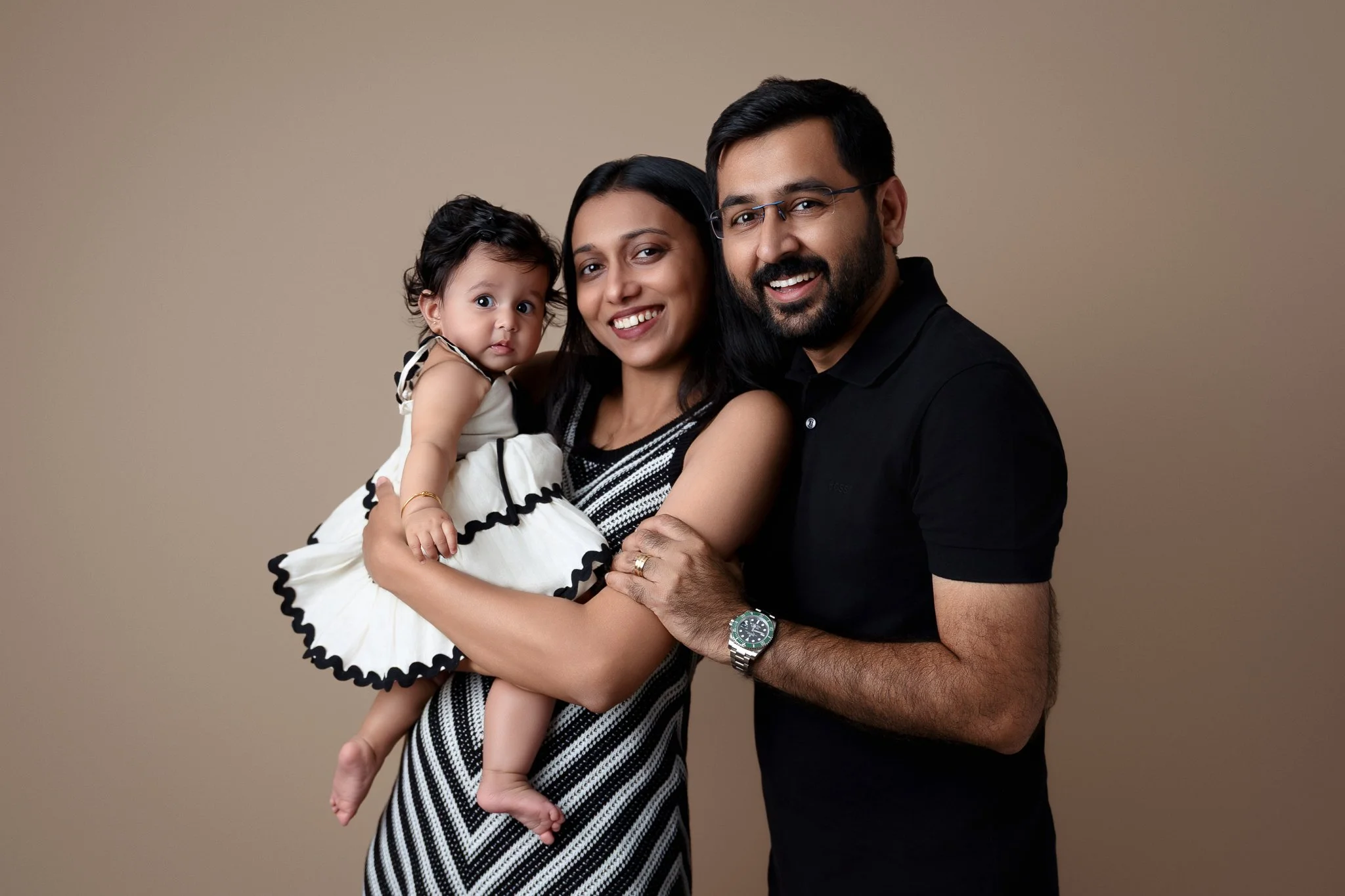 family posed with toddler