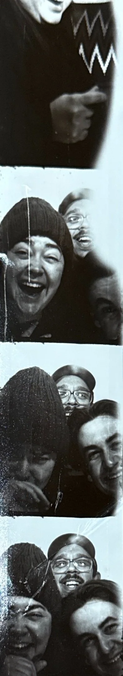 Black and white photo booth pics of four friends making funny faces and smiling.