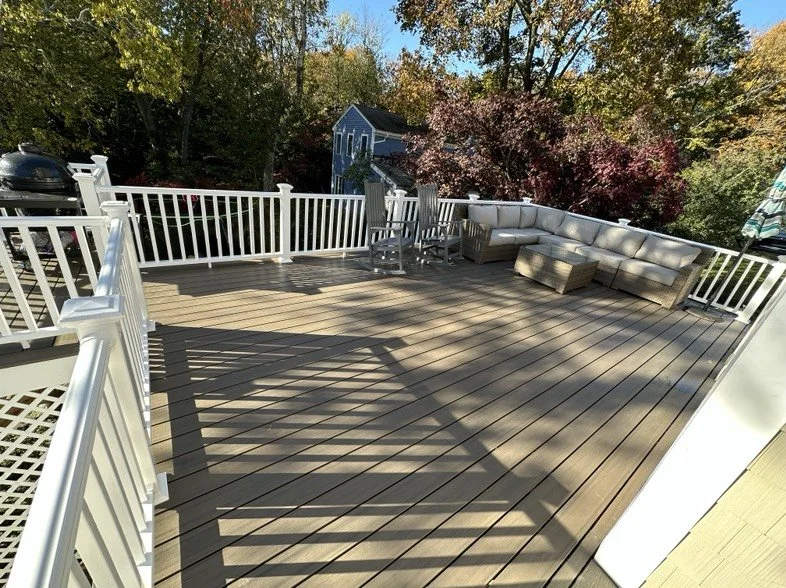 Composite deck with white railings in Braintree, Massachusetts.