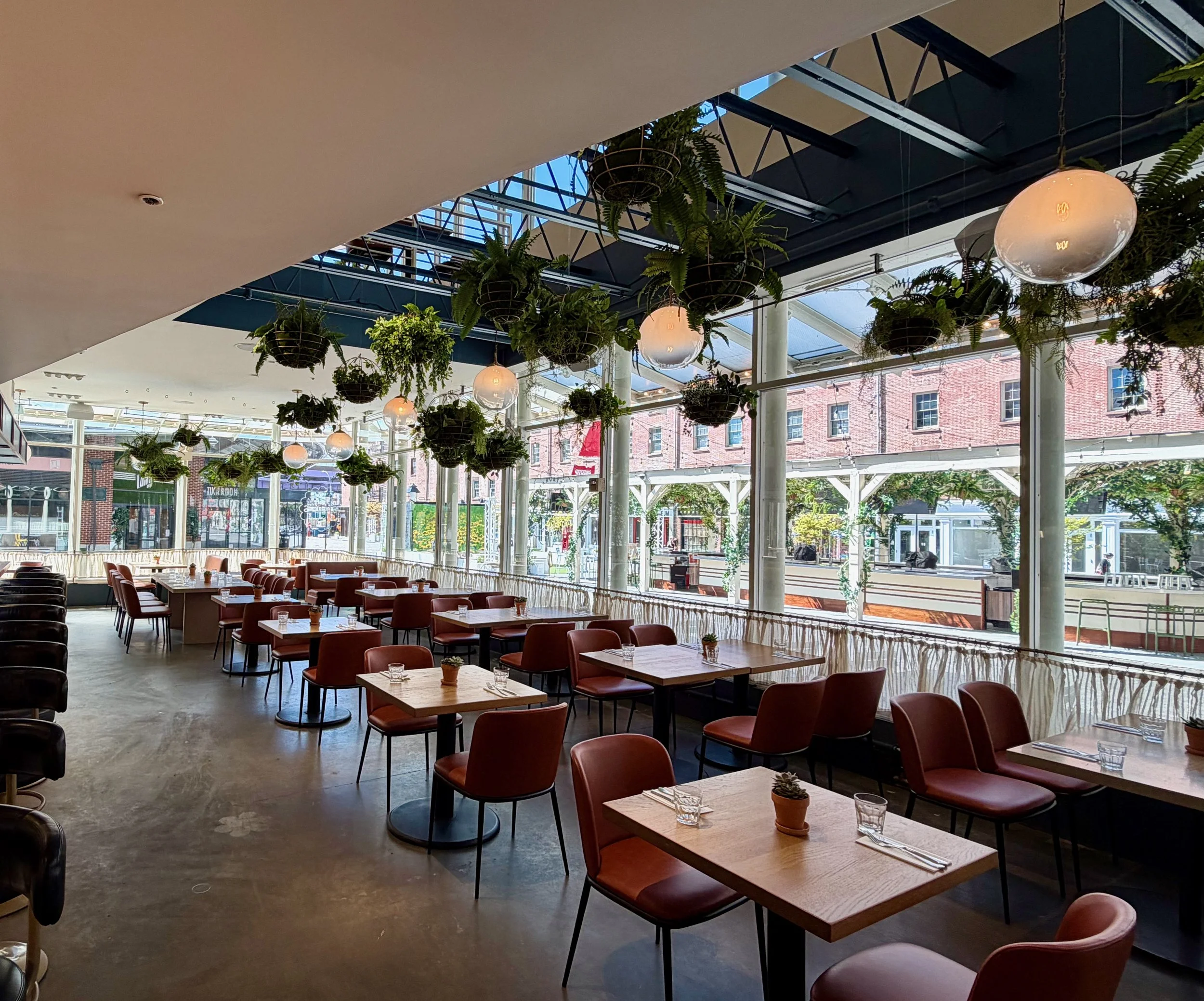 NYC Sadie's restaurant indoor with greenery installation on the ceiling