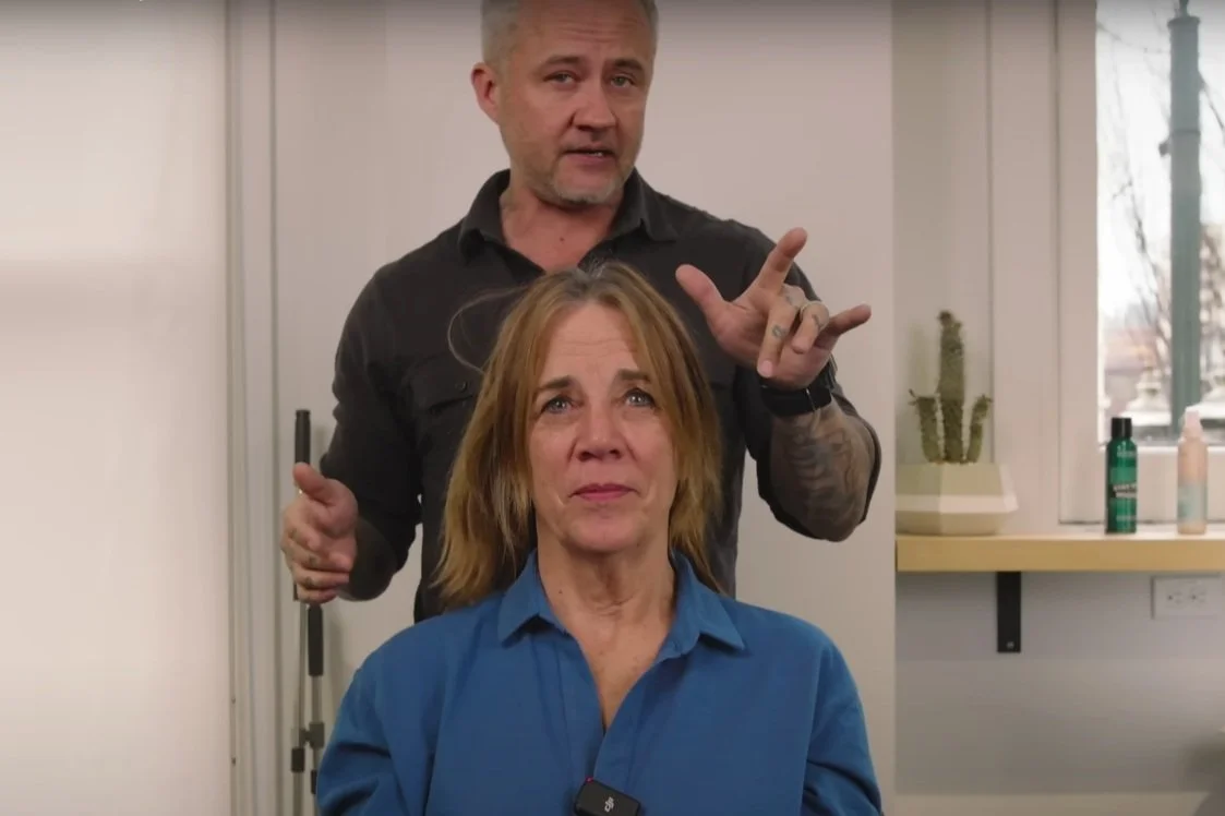 Justin Hickox discussing common hair mistakes with client Stephanie before her haircut transformation for aging hair concerns.