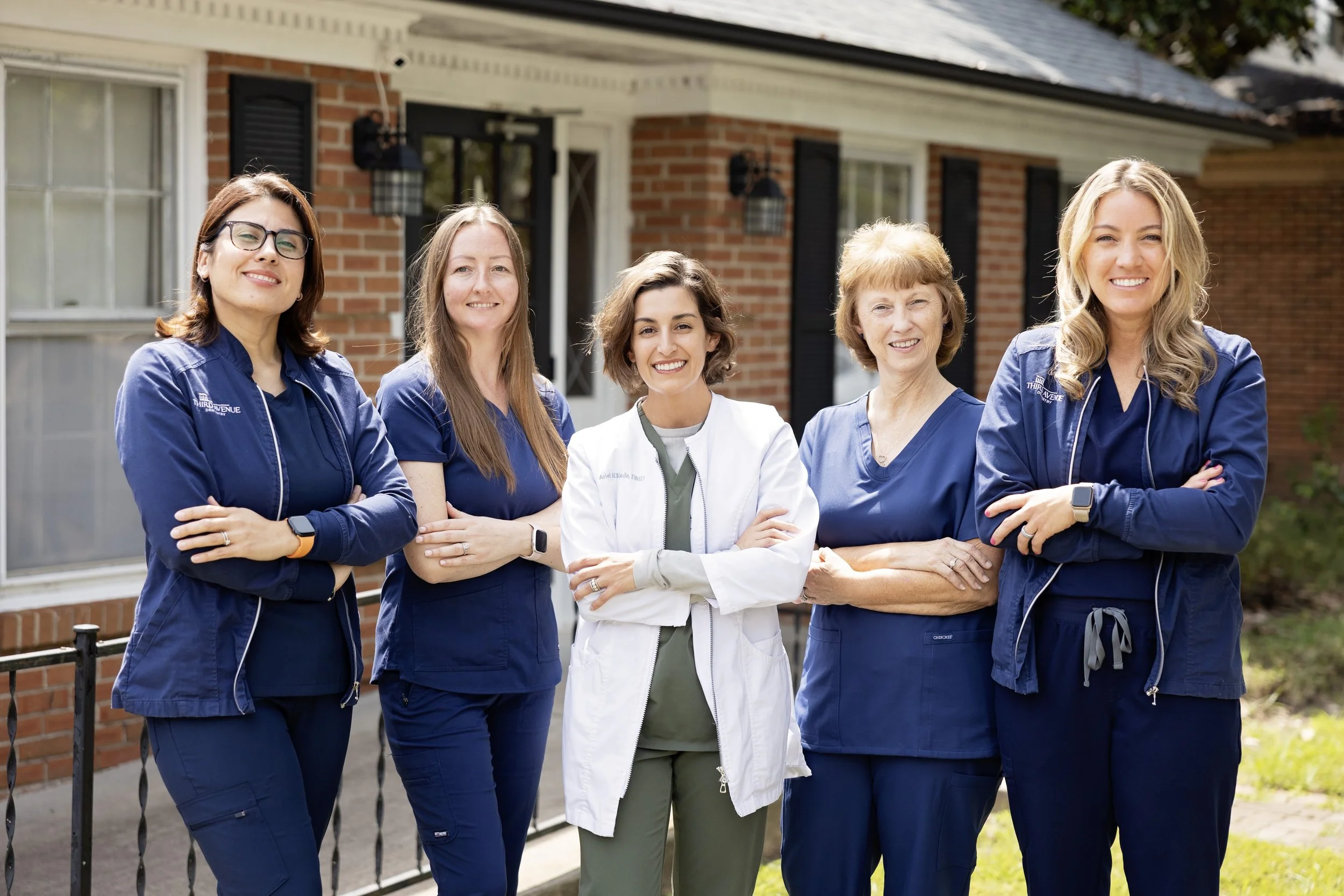 Dr. Ariel Kunde is standing with the Third Avenue Dentistry team in front of the Gastonia office