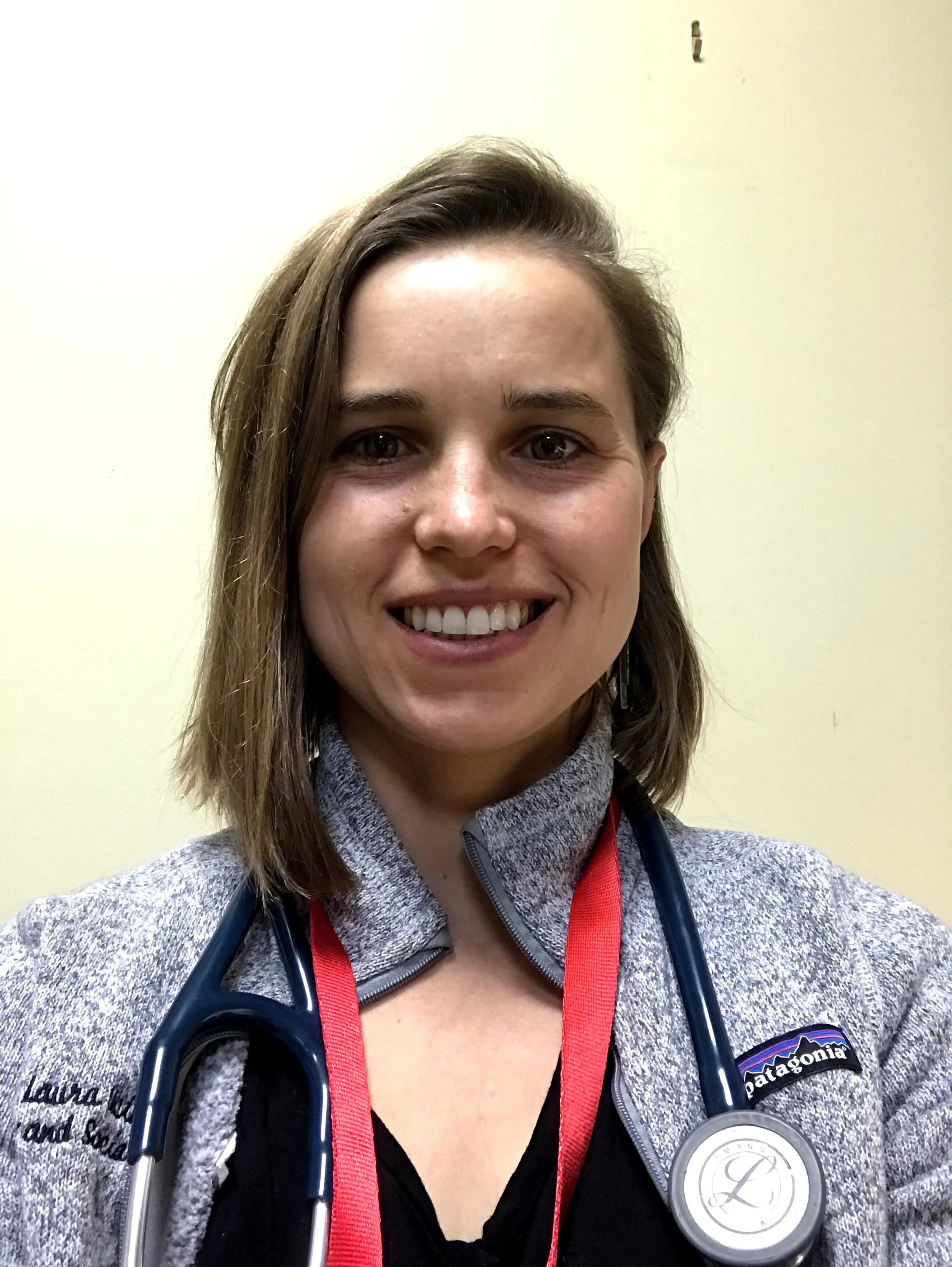 Photo of Laura Ucik smiling with a stethoscope around her neck.