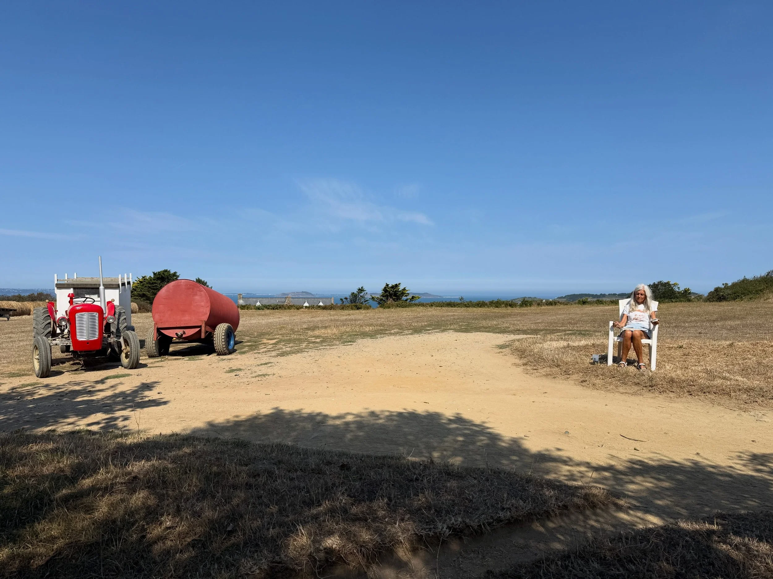A day of drawing in Sark with @cynthiaharrisonorr. I&rsquo;m sat in the shade in Little Sark looking out over Herm Jethou and Guernsey in the distance while Cynthia braves the heat of the morning drawing the lovely corrugated iron roof of the barn be