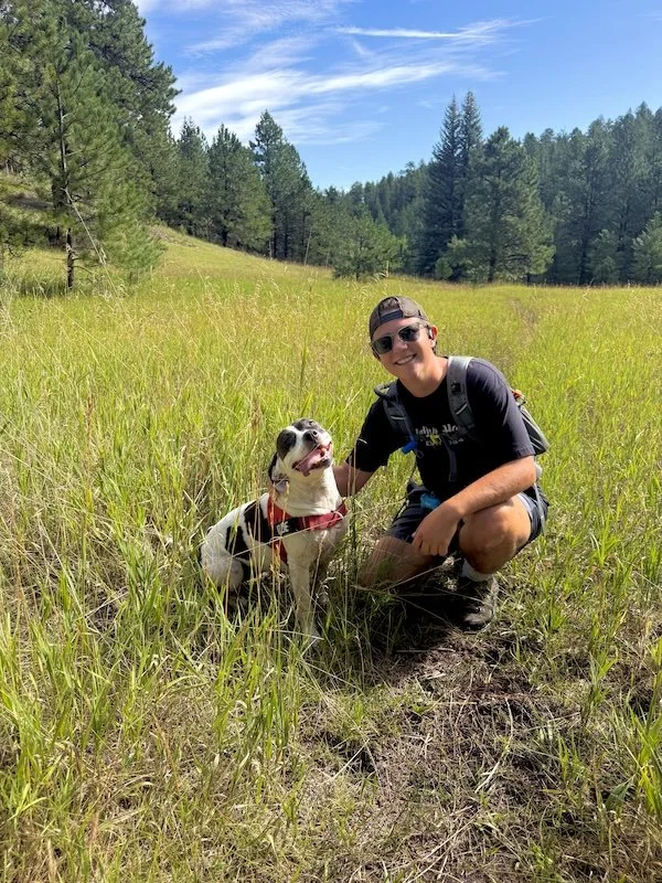 Kasey hiking with a dog