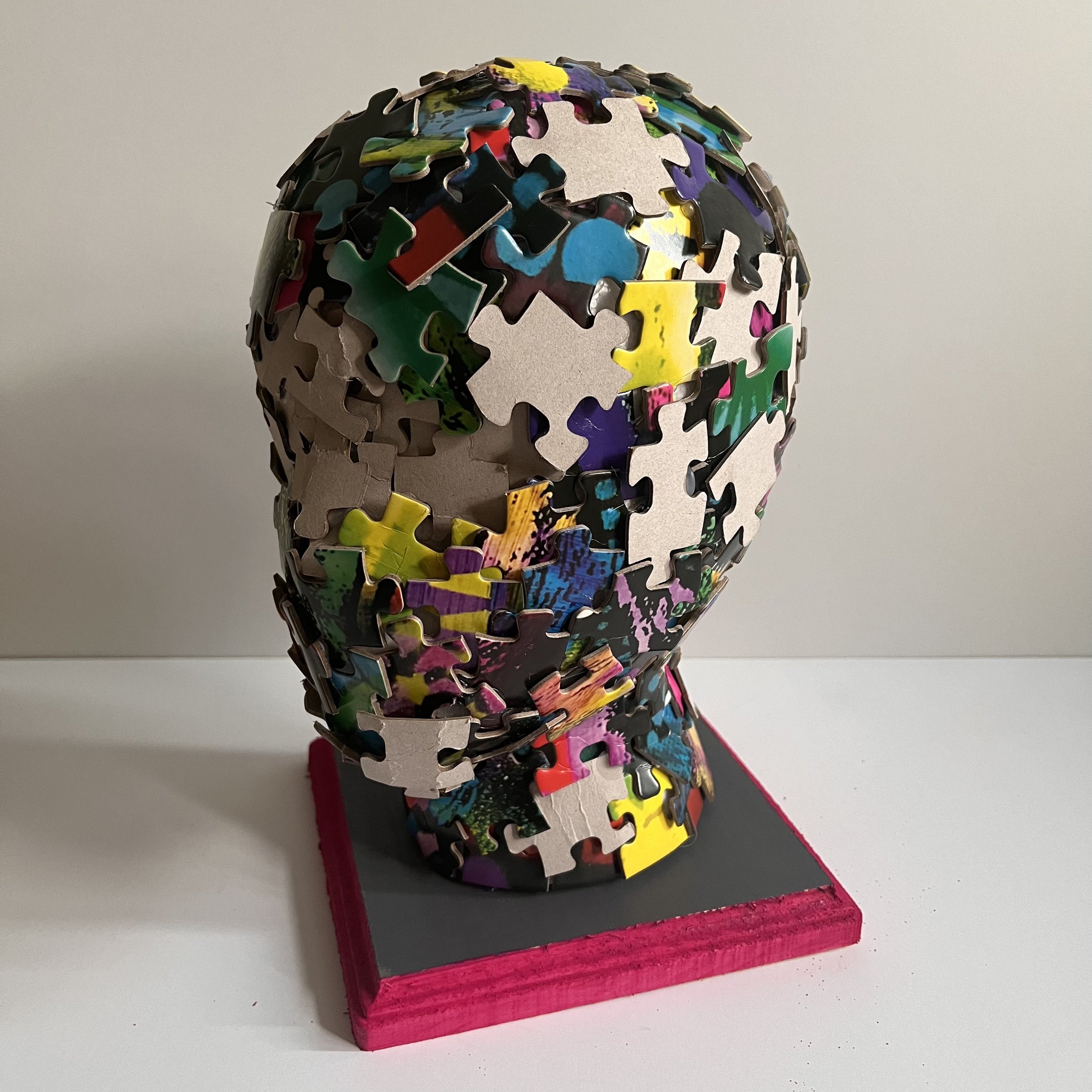 Reconstructing Identity: This piece illustrates how I reconstructed my identity after surgery. I tried to put the pieces back together, but not everything matched. Imagine trying to put a puzzle together without vision or resources. This is why some