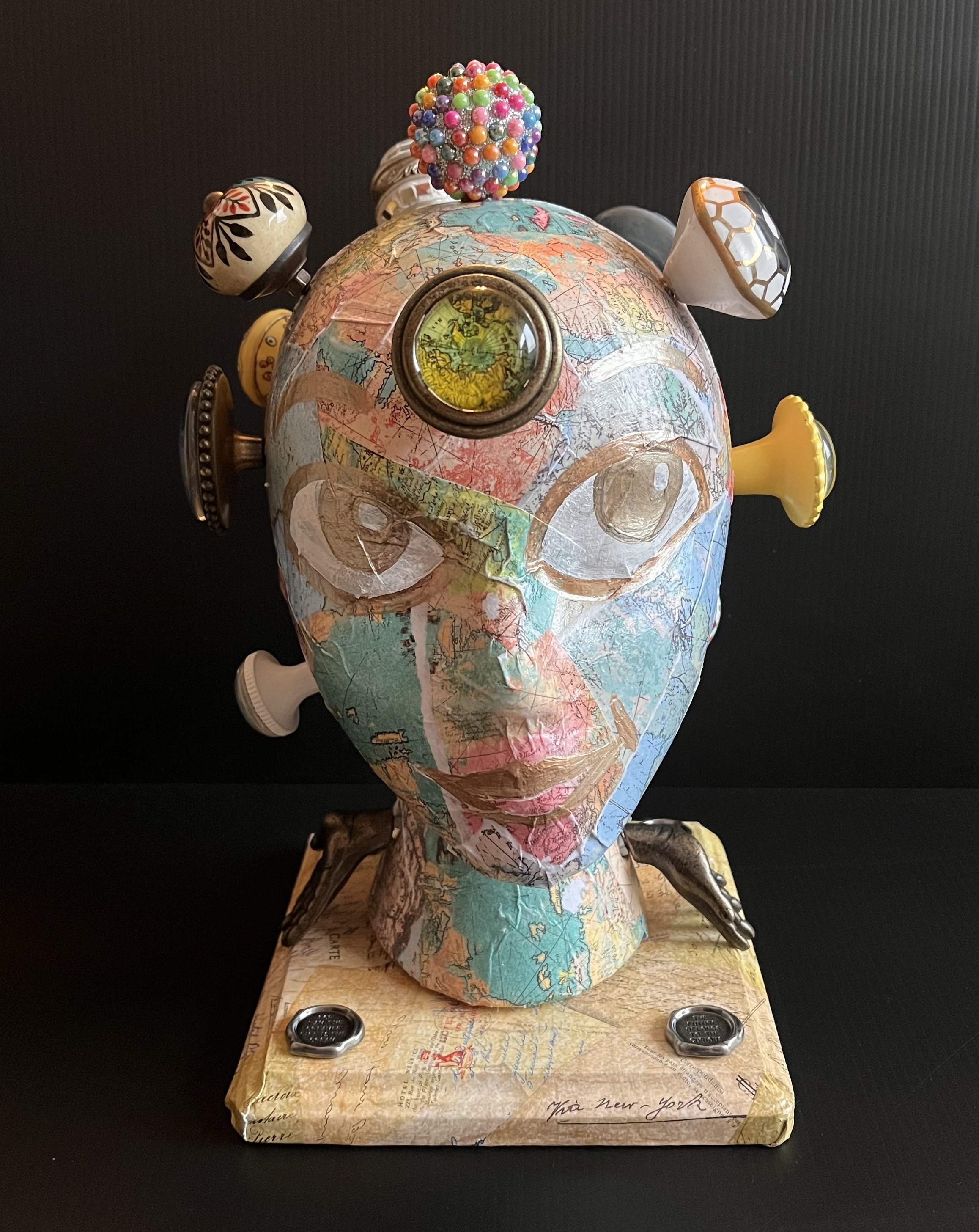 Oh, The Places You'll Go! : This represents my curiosity in exploring independence. I have my hands open on the side of the neck to reflect a willing stance. I placed a map around the head along with door knobs. If I were willing, doors would open, a