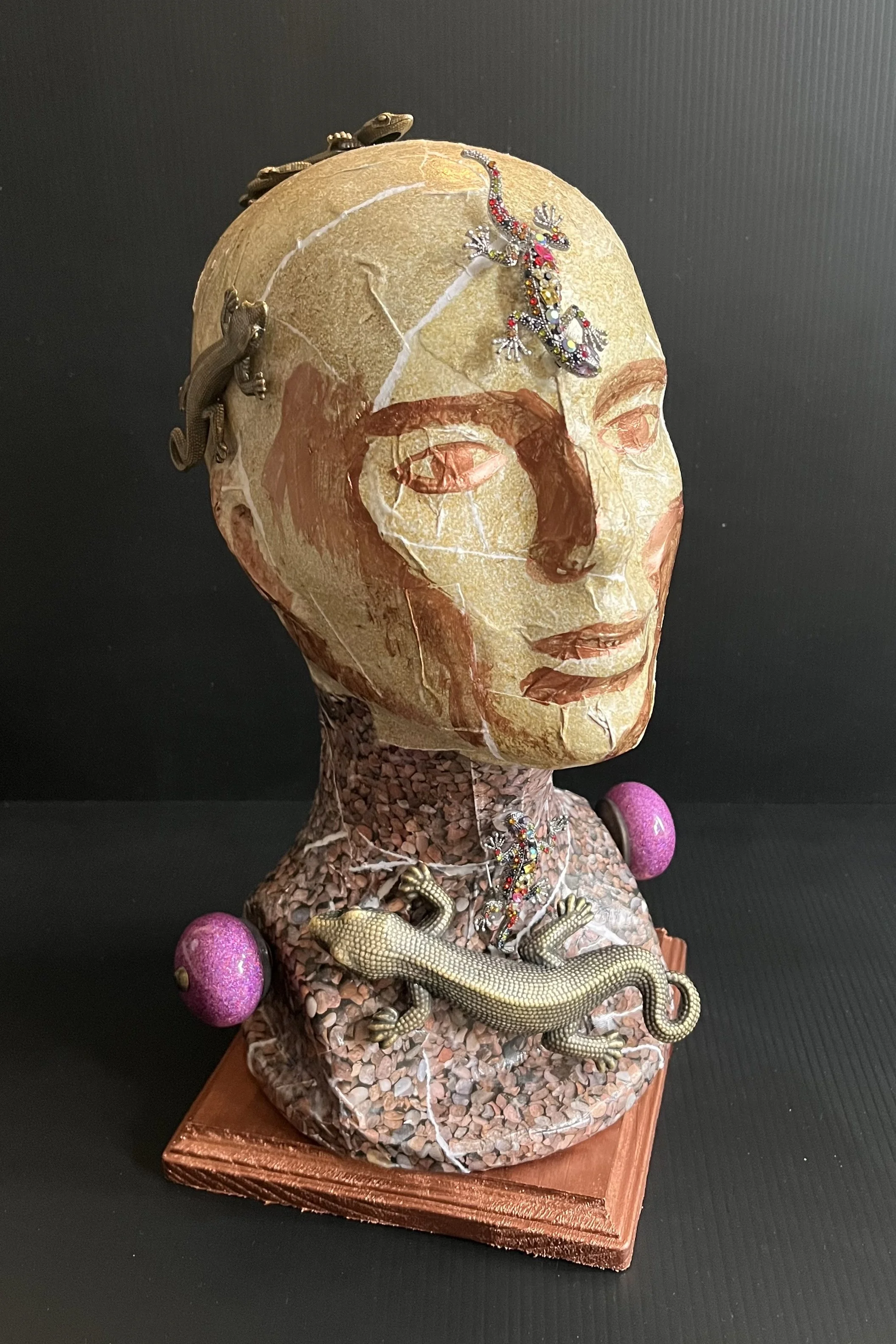 Re-Growth 2 of 2: This piece is the first humanistic sculpture I created. Lizards surround the piece, specifically on the throat, temporal lobe, and head. The lizards represent re-growth, and shedding your skin. The lizard reminds me to pull from my