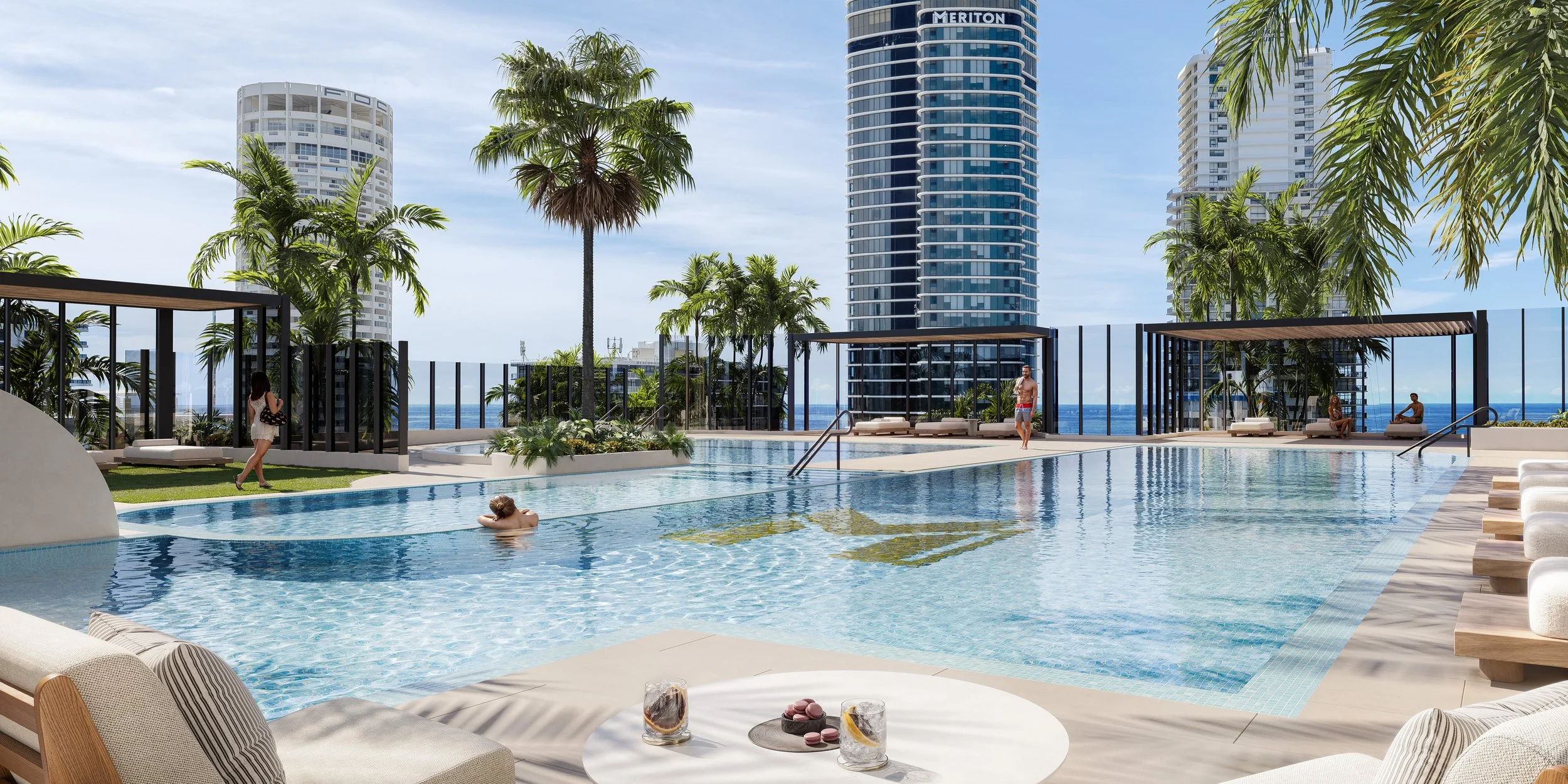 A rooftop pool area in a city with tall buildings, tropical plants, and lounge chairs.