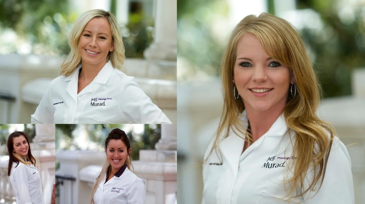 Four smiling women with long hair wearing white medical coats outdoors.