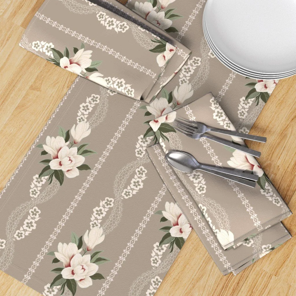 Table runner and napkins in Vintage 1910 Magnolia & Lace designed by surface pattern designer Julie McMillan. Available now in 6 colorways for fabric, wallpaper, and home decor on Spoonflower.