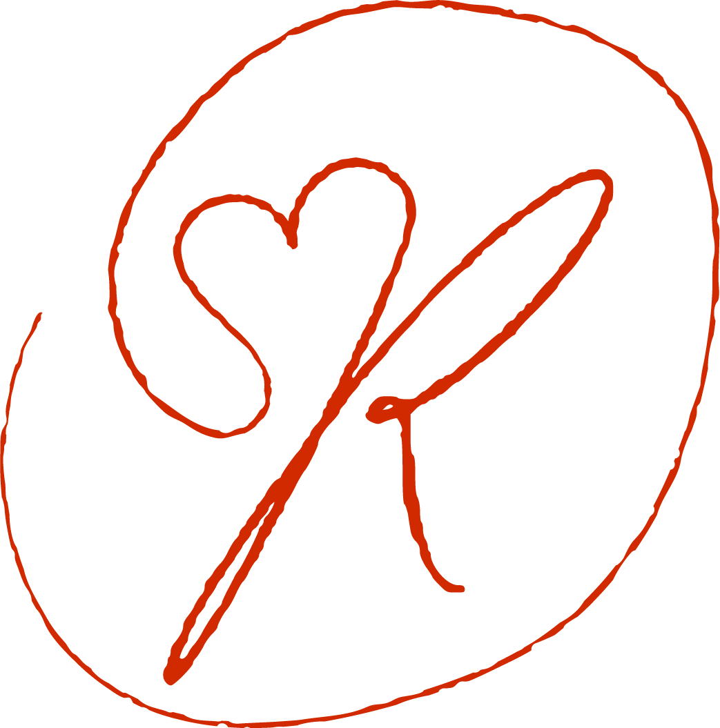 A black logo with a red outline, featuring a circle with a heart and a check mark inside.