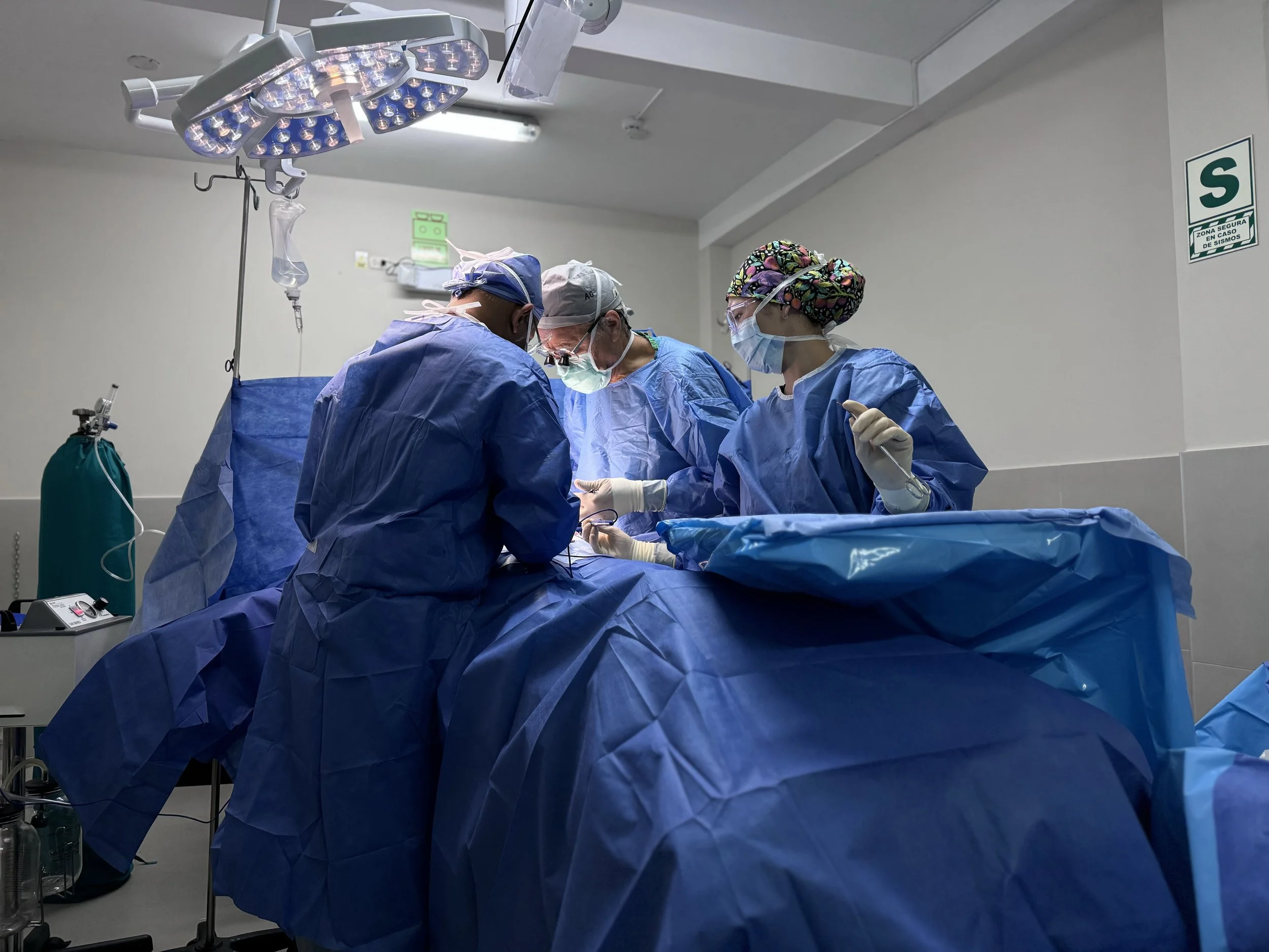 two surgeons performing an operating and a scrub nurse prepared with instruments