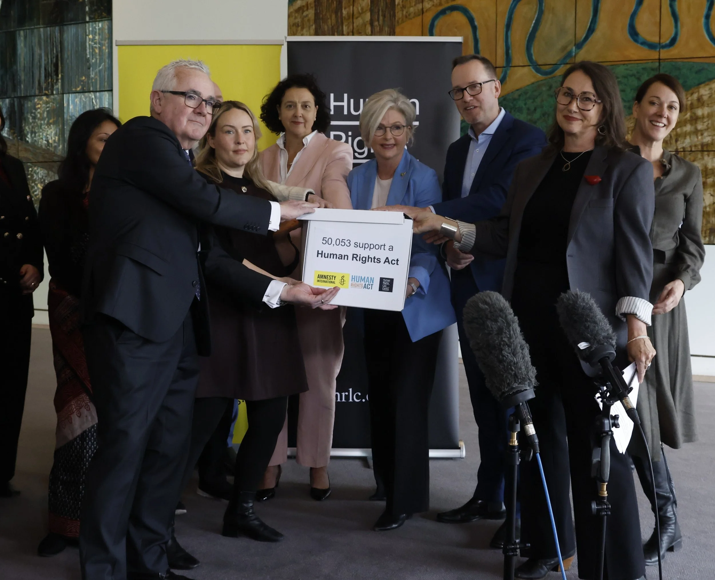 Photo of 50,053 signature Human Rights Act petition presented by HRLC and Amnesty to Andrew WIlkie MP, Monique Ryan MP, Helen Haines MP, SEnator David Shoebridge, and Sophie Scamps MP,