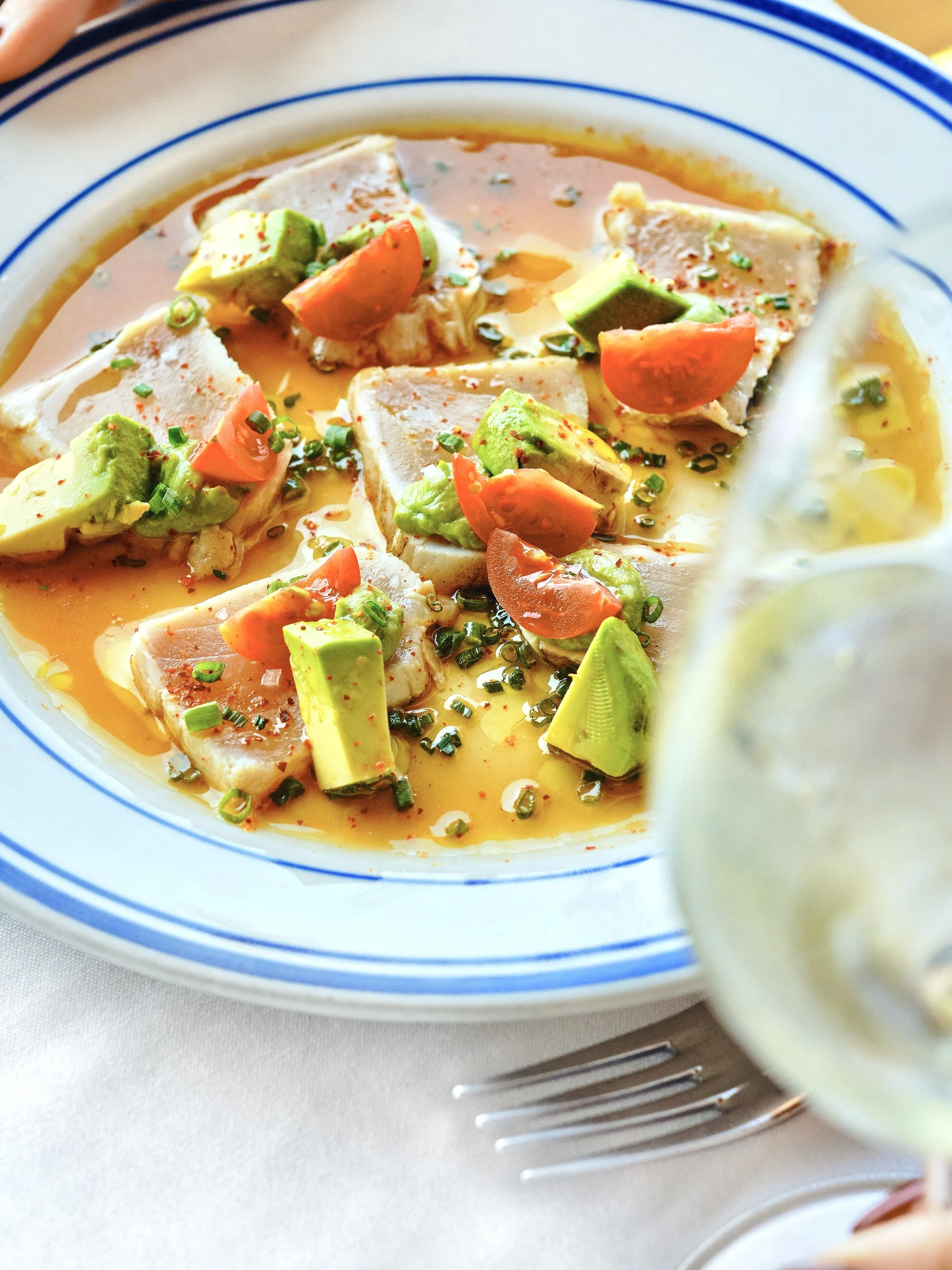 seared albacore dish with avocado and tomatoes