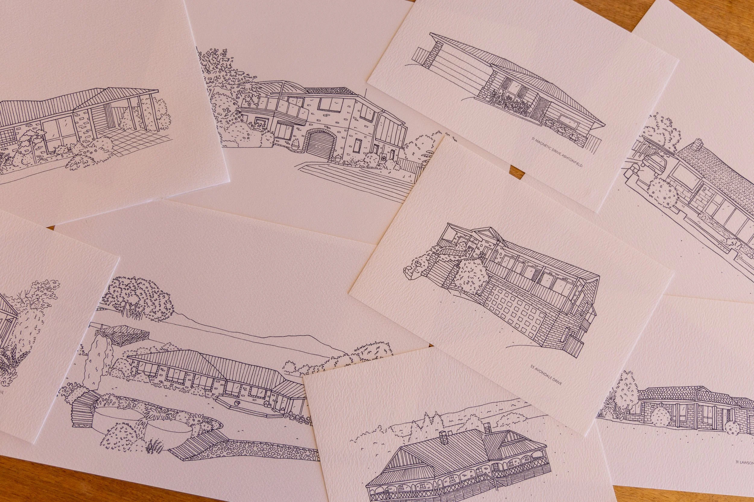 Collection of architectural sketches of various house designs on textured white paper.