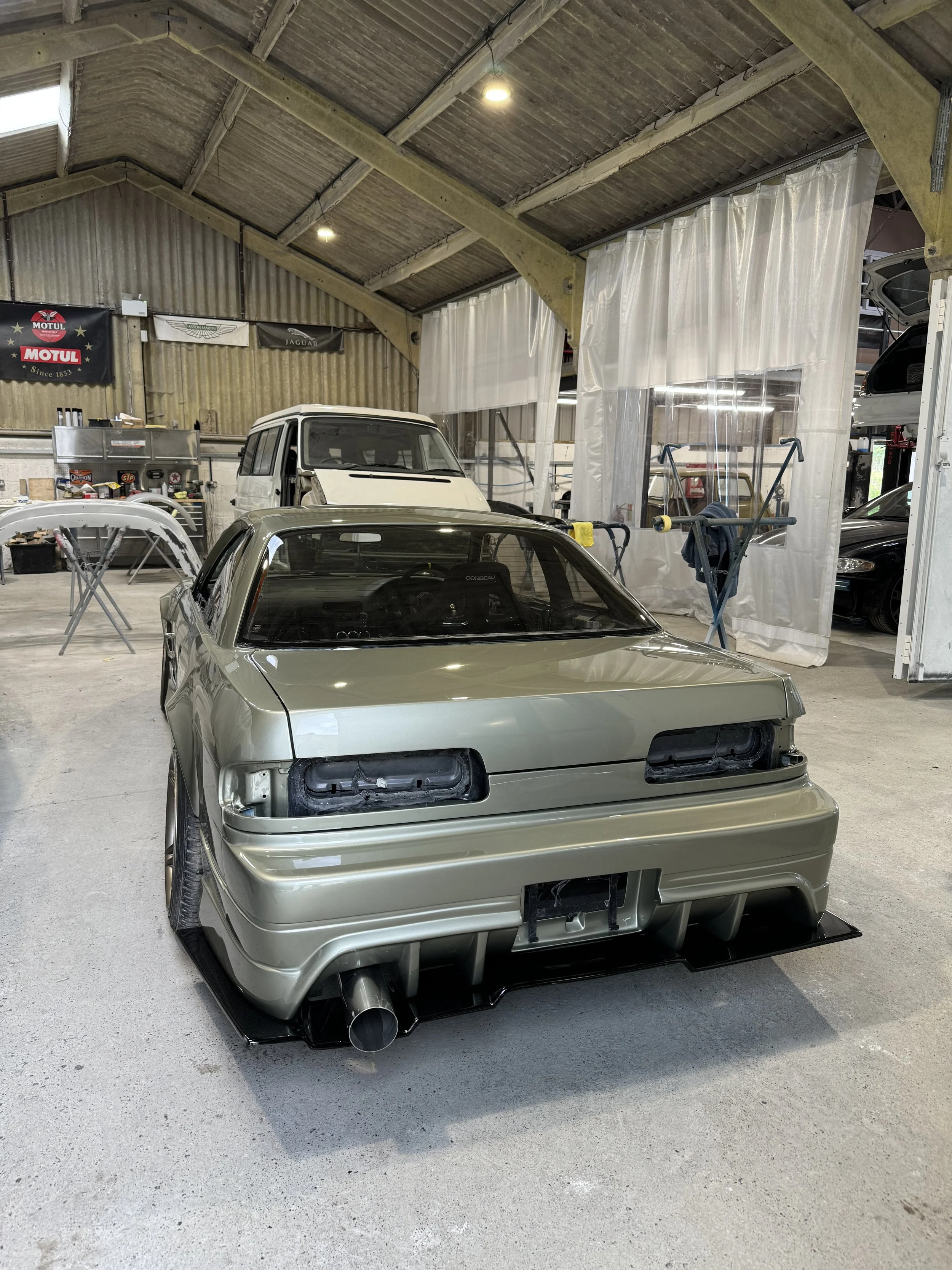 custom wide body nissan ps13 show car in workshop at concours classics