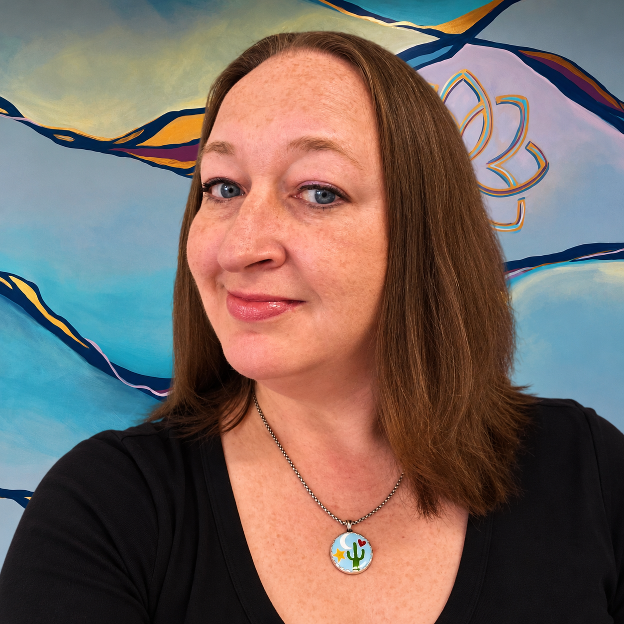A woman with long brown hair wearing a black top and a black choker necklace, smiling in front of a colorful abstract mural.