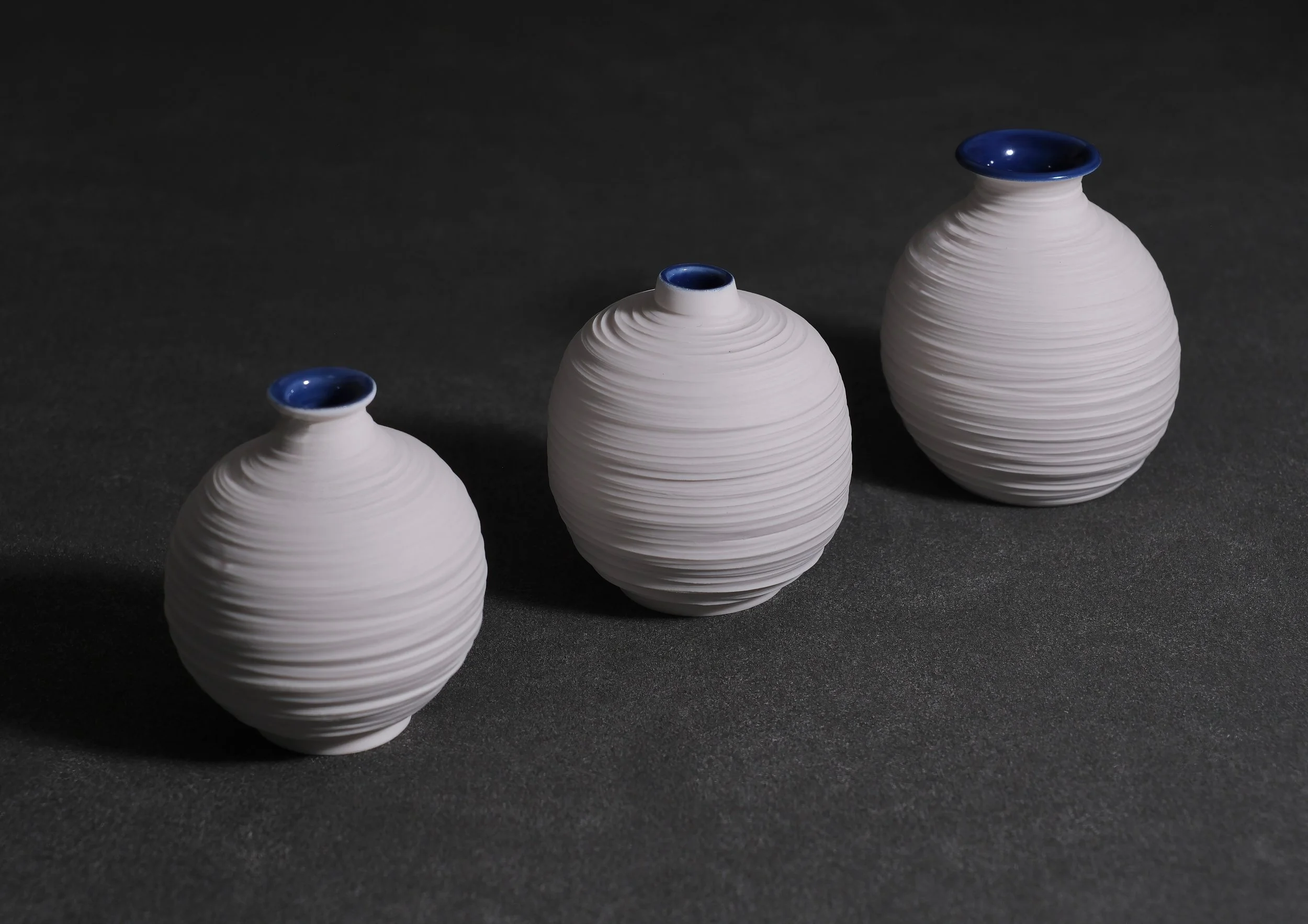 HOLD / STILL (globe) - a series of porcelain vessels that pause to rest. Able to stop and embrace the moment. Wide ranging in size from petite to much larger. Carved naked exteriors with glazed interiors.