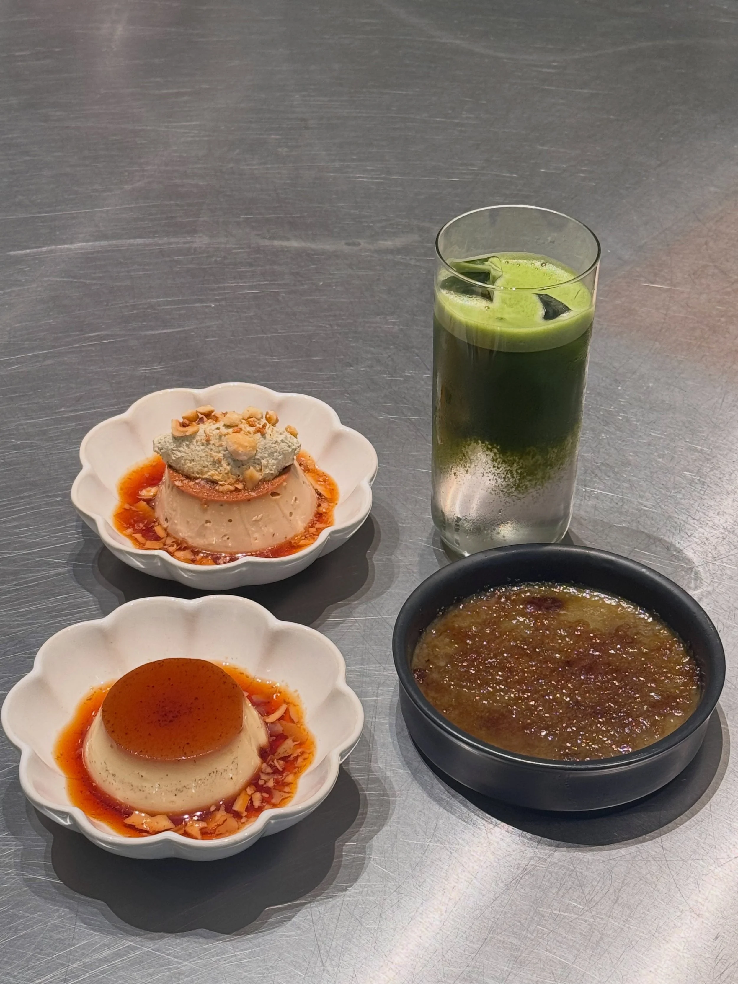 Items that will be leaving our menu soon as we are preparing for our new menu! 🍮

Which items will you take for the last time before they are gone? 

#kagematcha #kagebrussels #matchacremebrulee #matchalychee #caramelflan 

Matcha Cr&egrave;me Br&uc