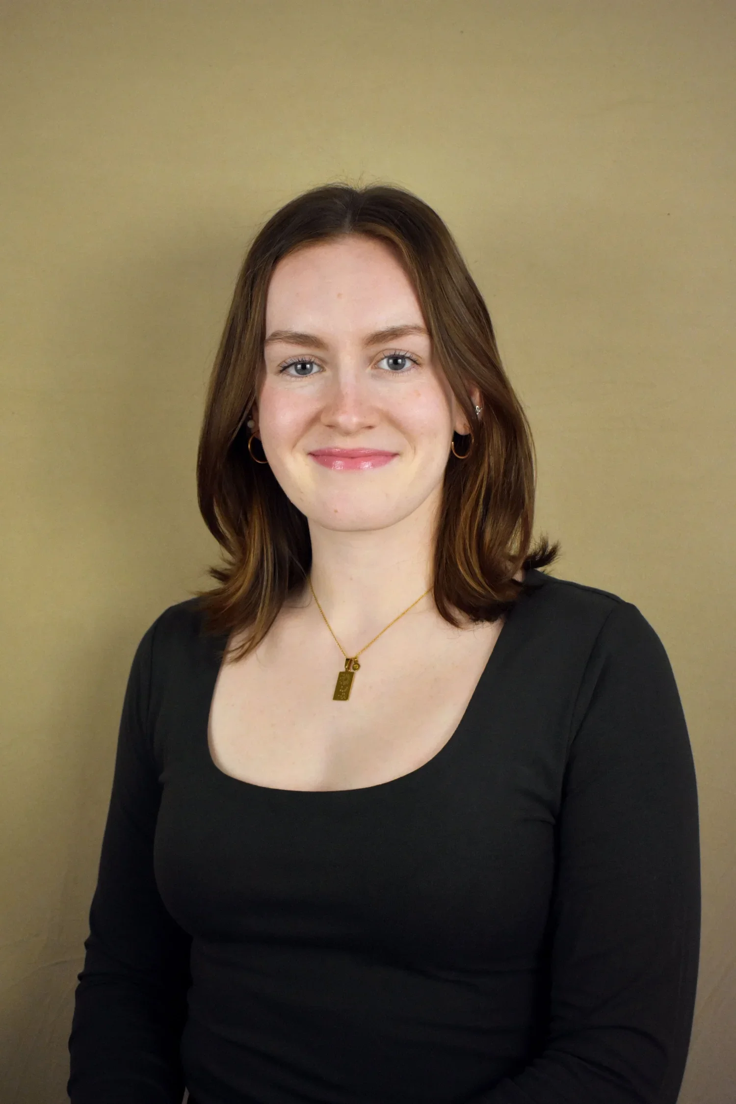 A photo of Paola Ortega standing in front of a window.