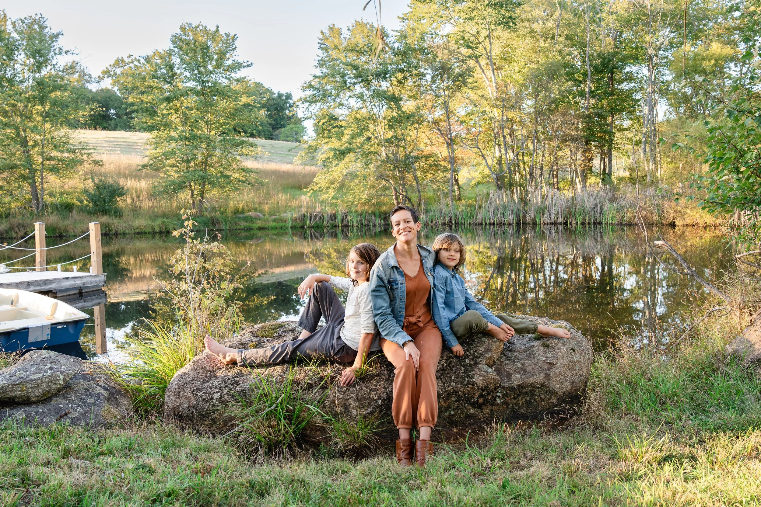  Wide view of a mother and her two boys beside the pond at Grey Oaks Farm during a Virginia autumn evening. 