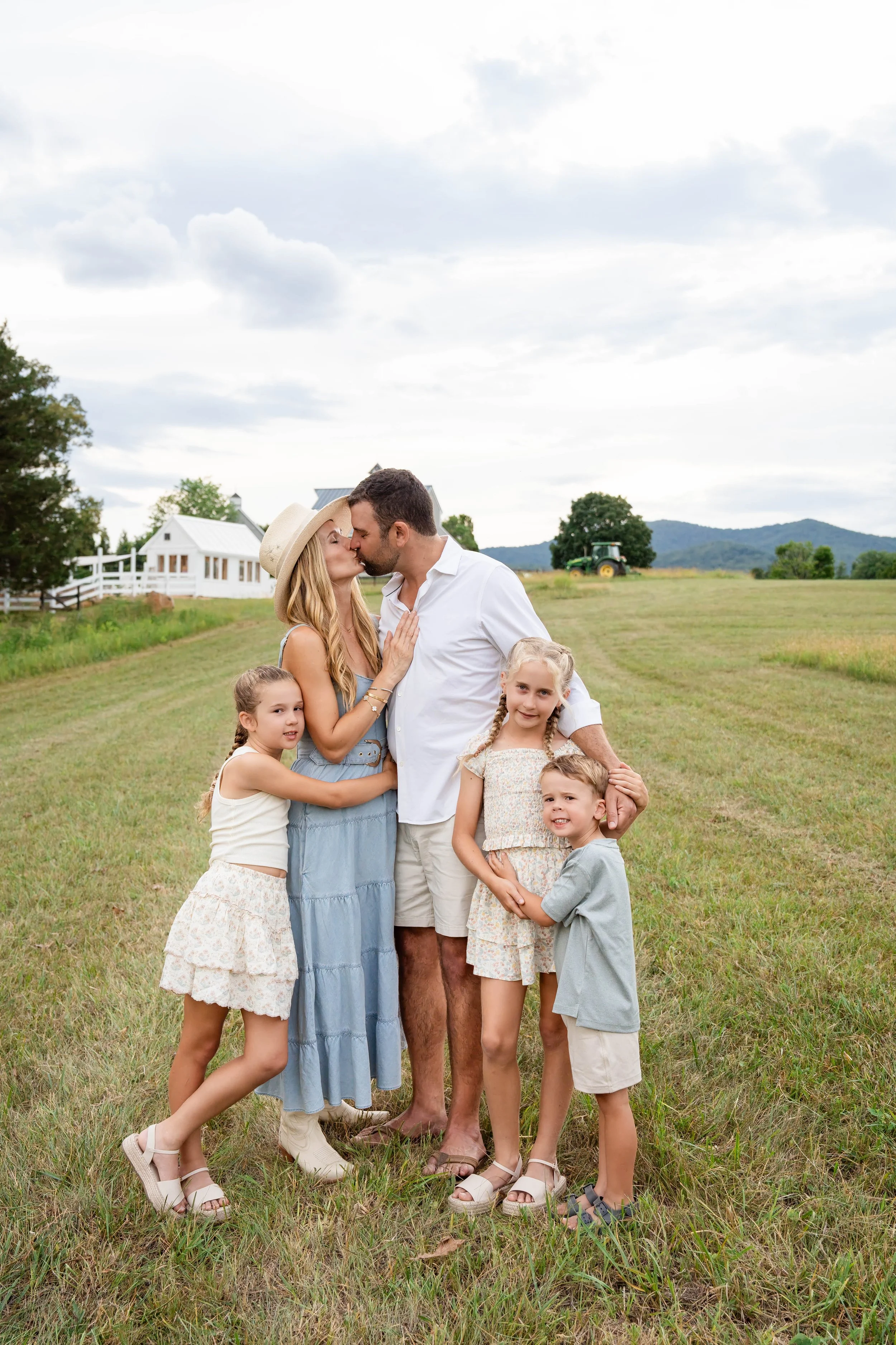 Family of five together in a sunny meadow