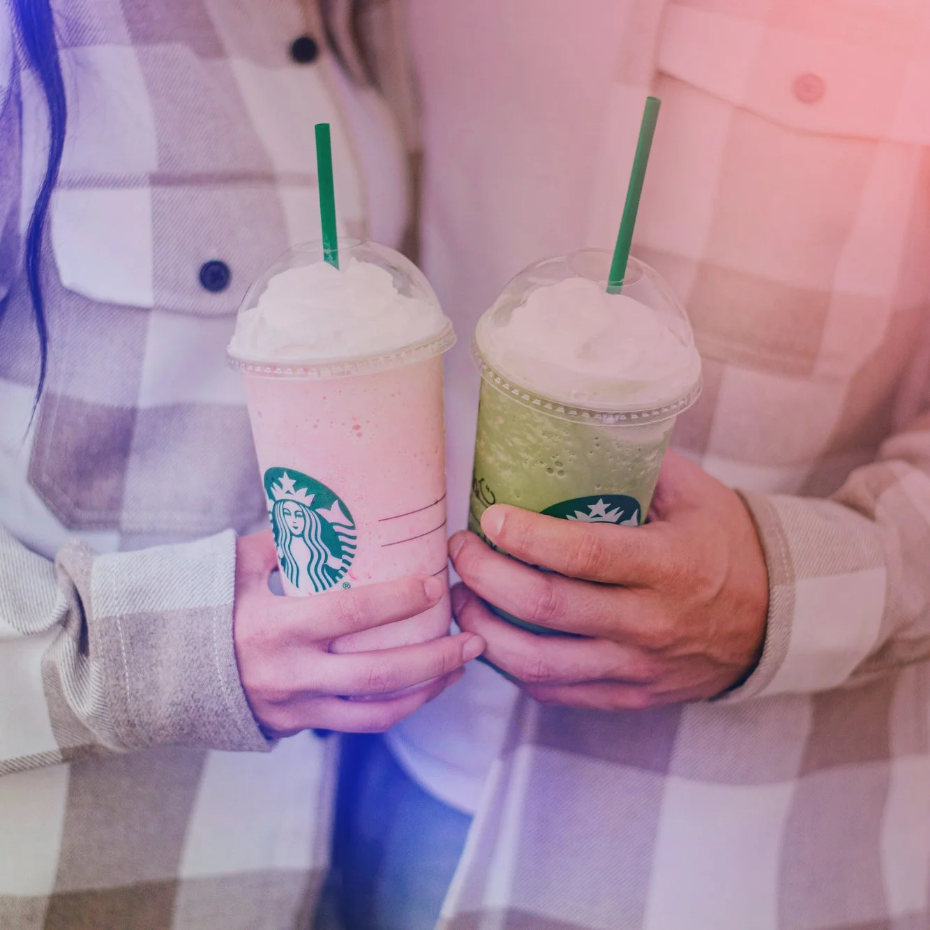 Two people holding Starbucks drinks representing branded campaign music composition.