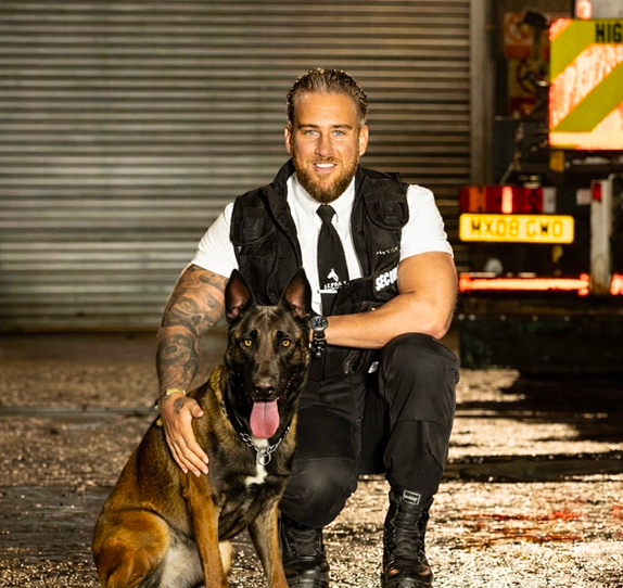 Security officer with guard dog providing protection services in Oxford