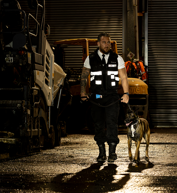 Security dog handler working at industrial site in Bristol