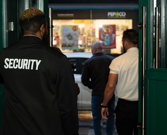 Retail security guard managing access and customer safety in Bristol