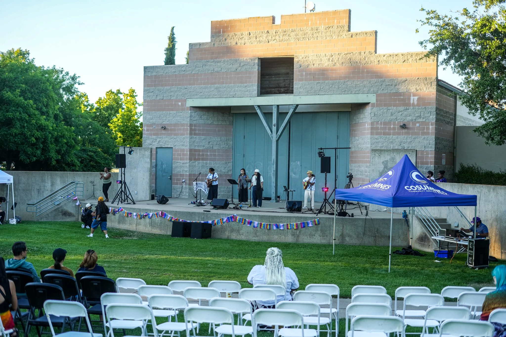 Wide view of an outdoor community festival with professional live sound rental, PA speakers, stage monitors, and event audio production in Sacramento.