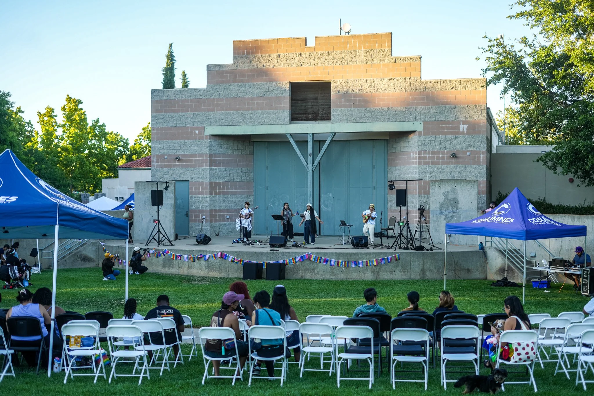 Wide view of an outdoor community festival with professional live sound rental, PA speakers, stage monitors, and event audio production in Sacramento.
