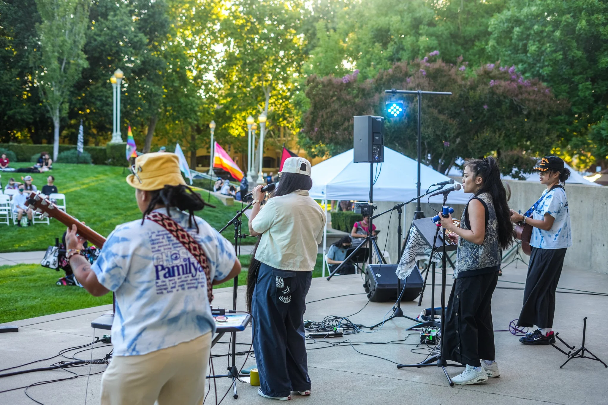 Live band performing with professional PA speakers, microphones, stage monitors, and outdoor live sound rental at a Sacramento community festival.