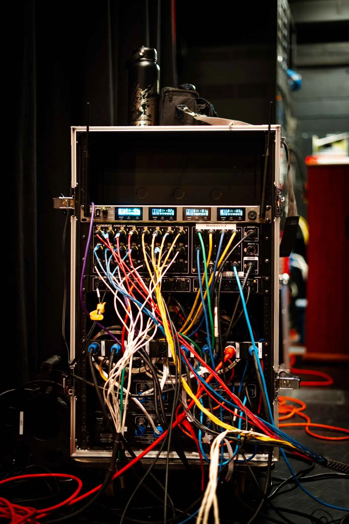 Professional live sound equipment rack with stage box and signal splitter cables for concert and festival audio production