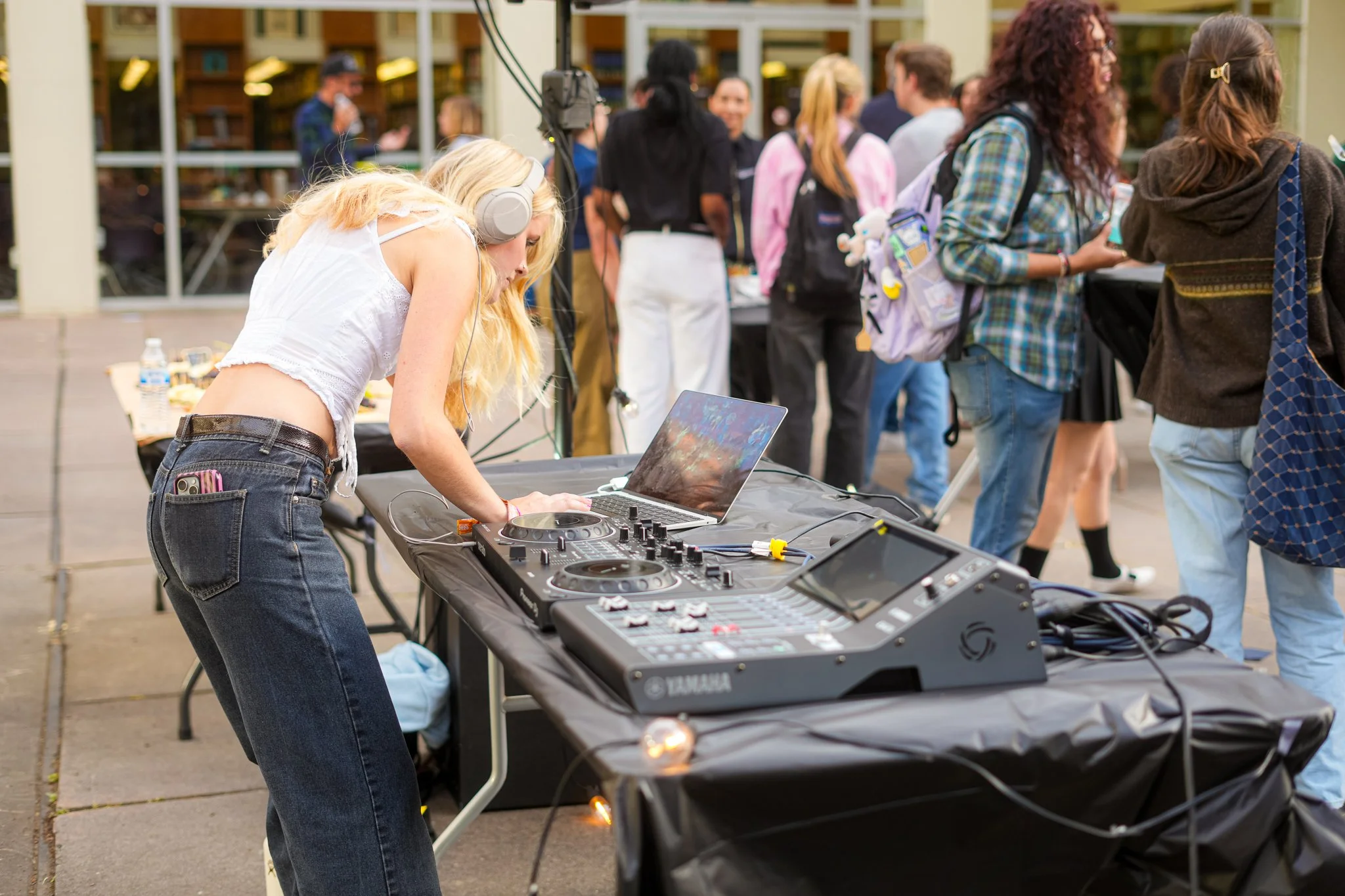 Professional DJ mixing music at a Sacramento networking event with premium live sound equipment, PA system, and audio production services.