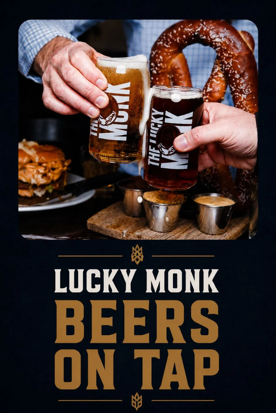 Two hands holding beer glasses with 'LUCKY MONK' logo, a large pretzel in the background, and a plate of food with dipping sauces on a wooden table, promoting beers on tap.