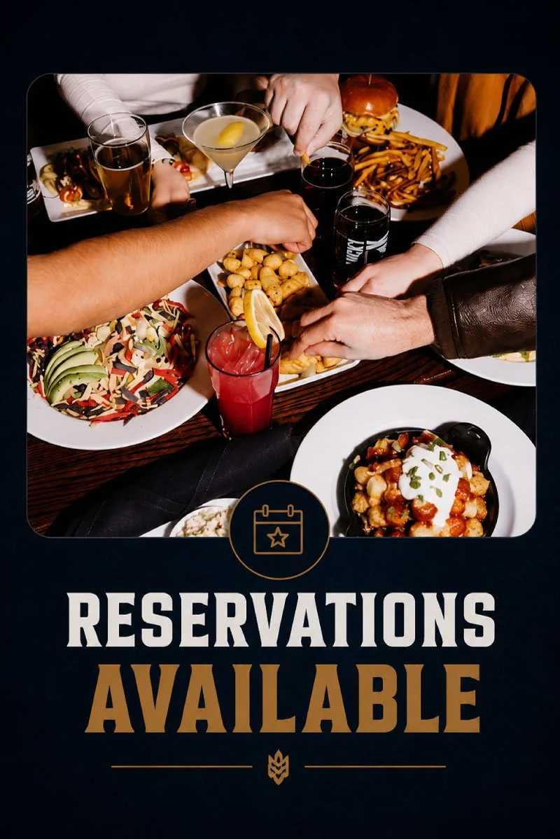 People sharing a meal with various dishes including fries, salad, and drinks at a restaurant