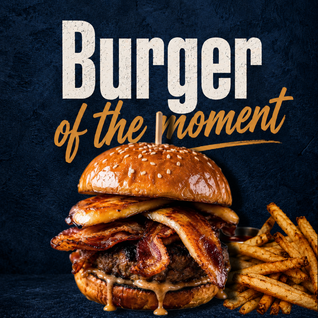 Close-up of a gourmet burger with bacon, cheese, and a sesame seed bun, served with a side of crispy fries on a dark textured background.