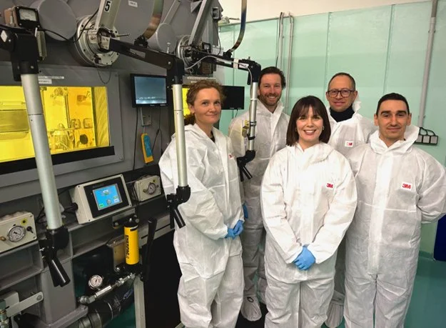 Team in-front of innovative machine